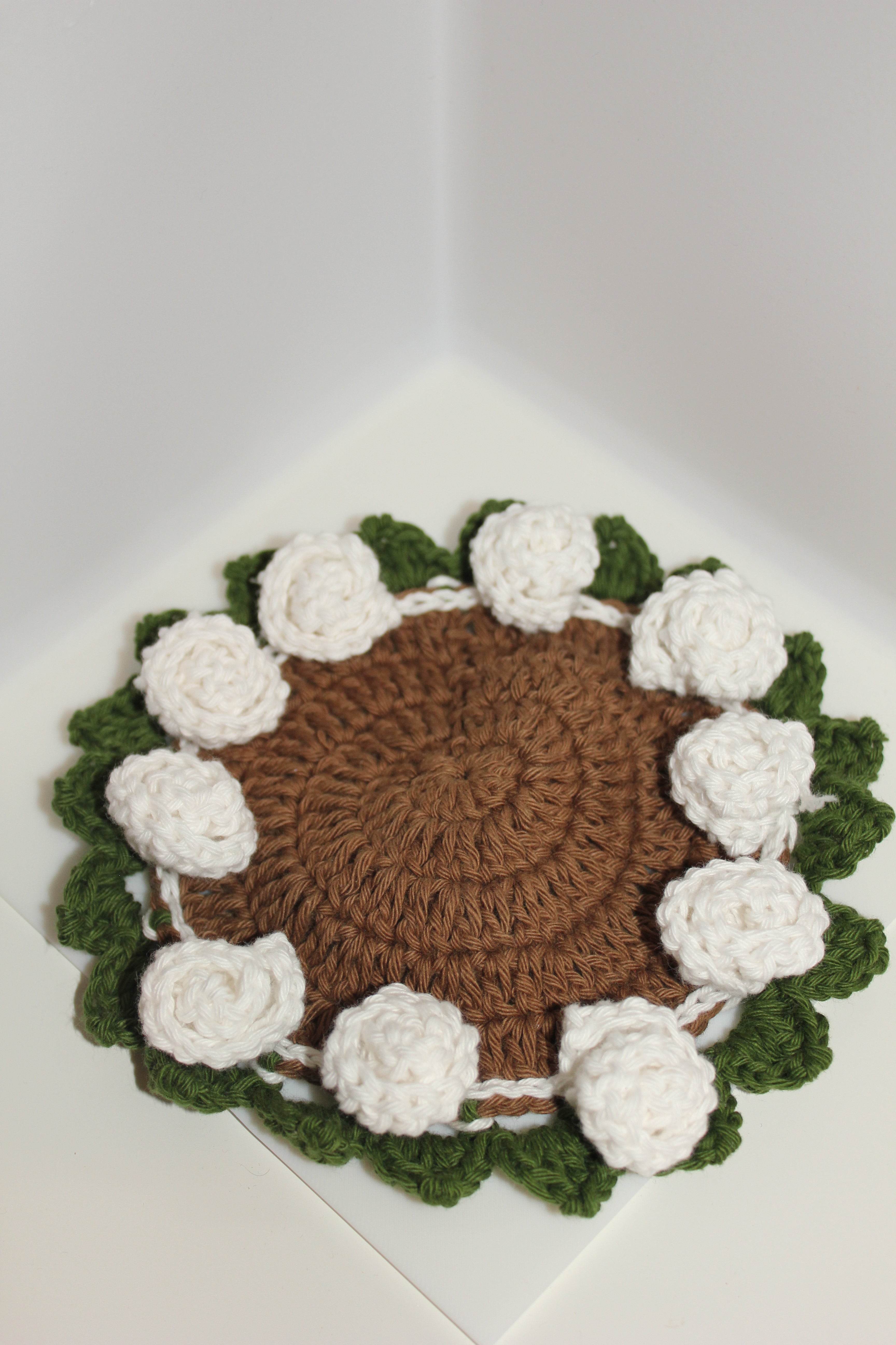 white roses green leaves coaster top view