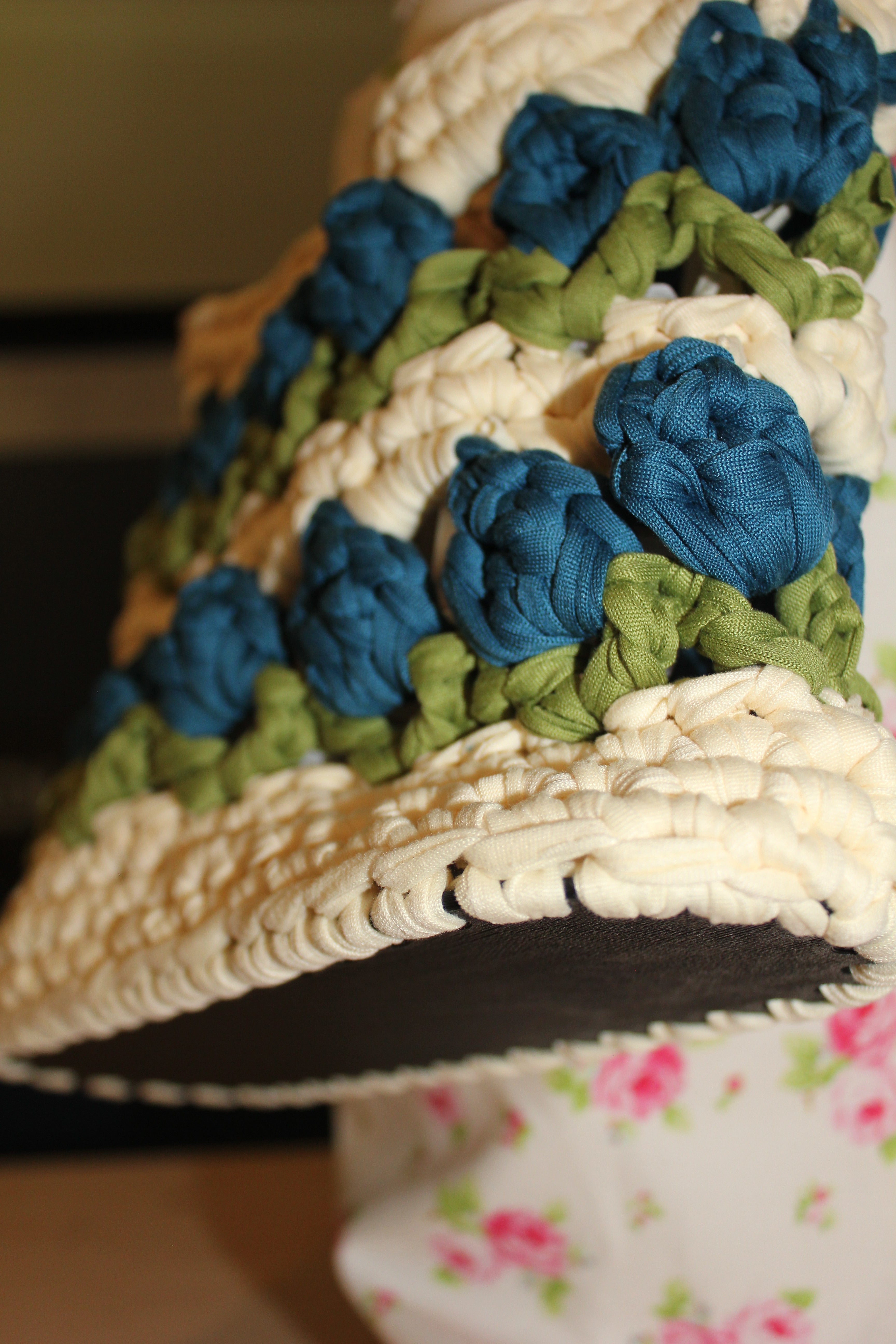 Crocheted tulip bag with blue and green flowers. bottom view