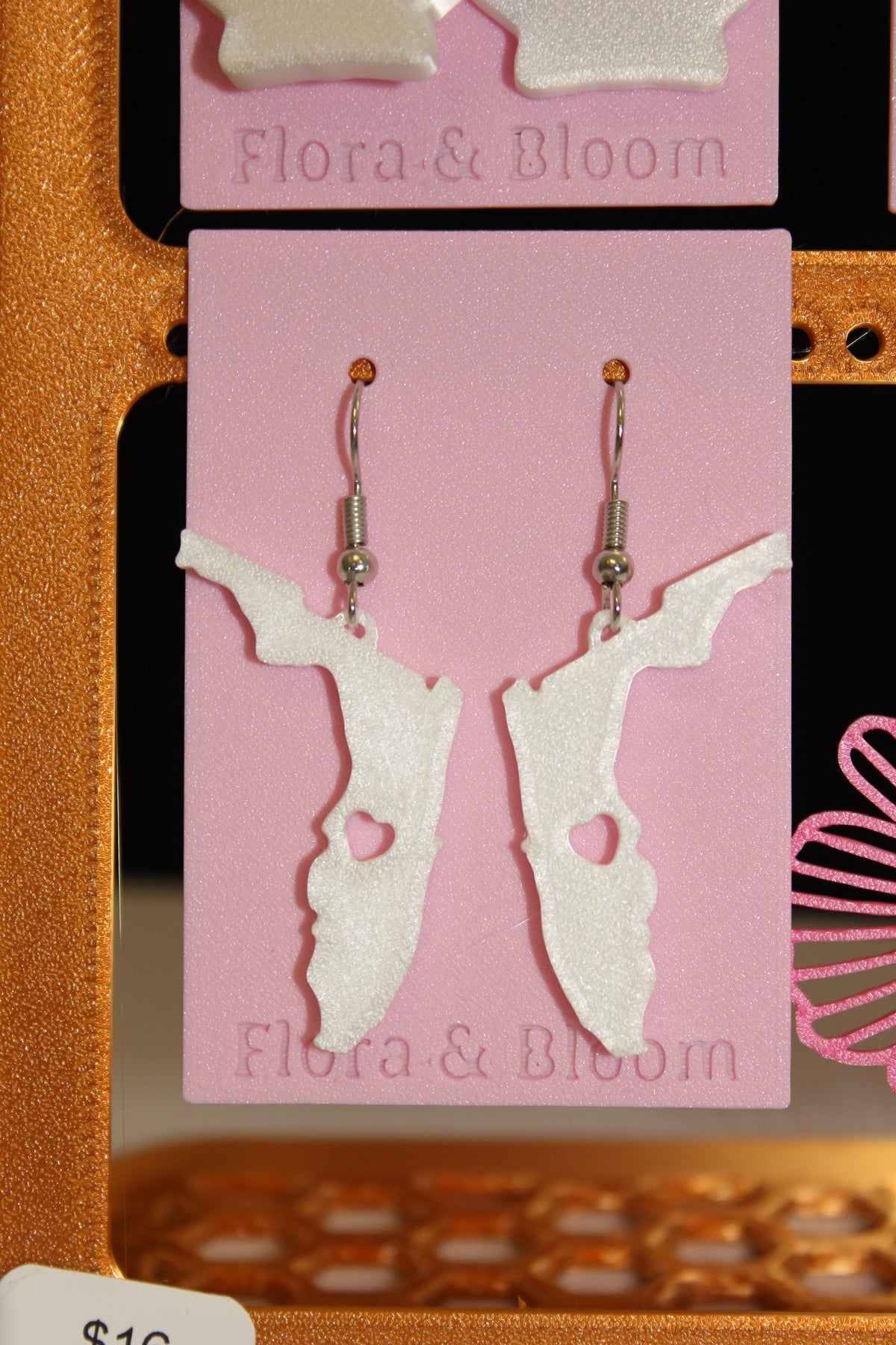Florida shaped earrings on a pink 'Flora & Bloom' card.