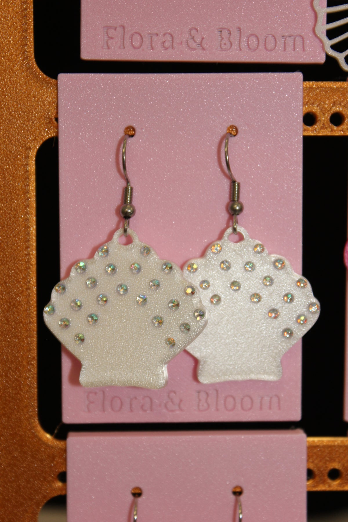 Rhinestone Seashell earrings on a pink 'Flora & Bloom' card.