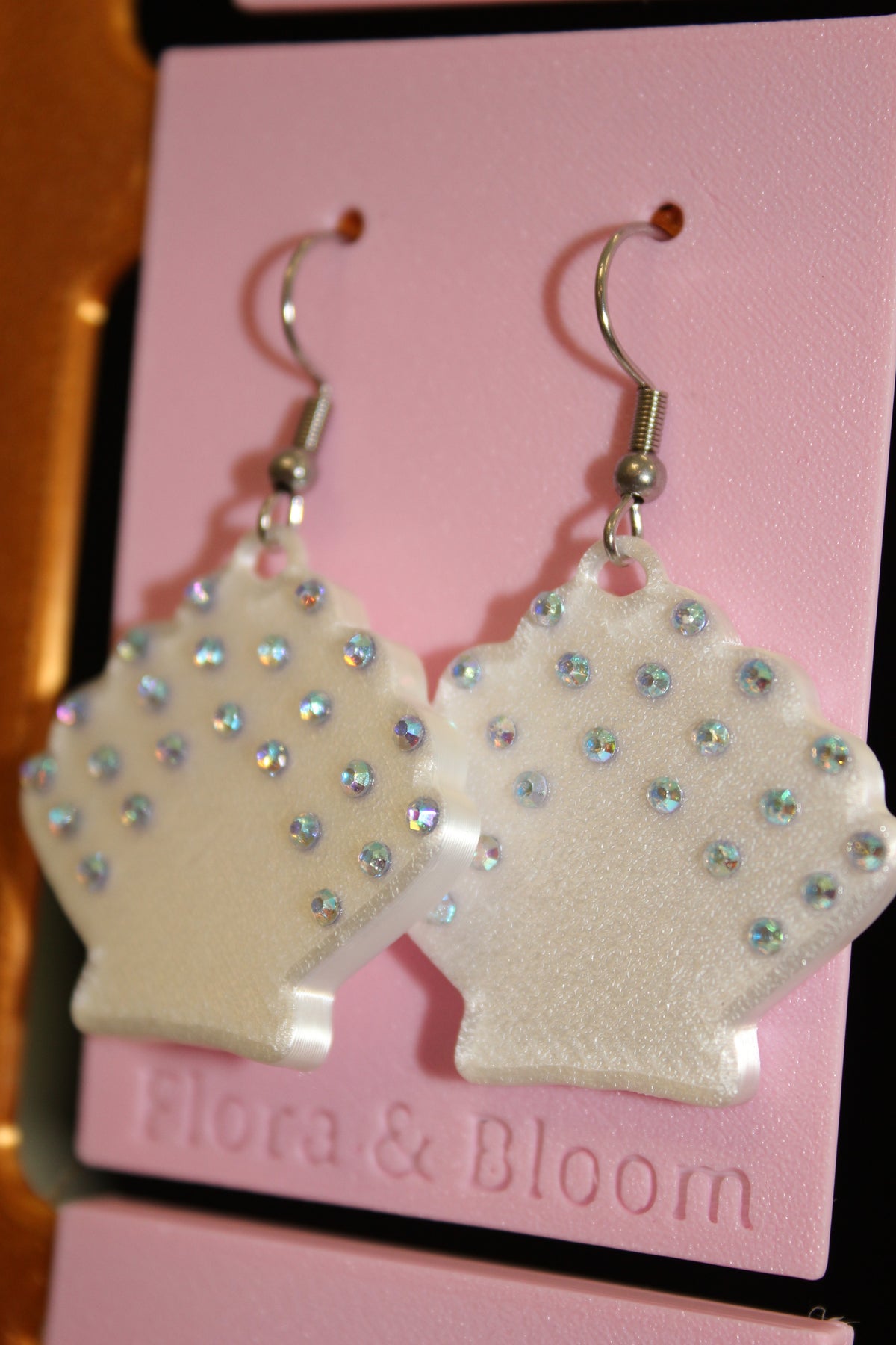 Rhinestone Seashell earrings on a pink 'Flora & Bloom' card. Side view
